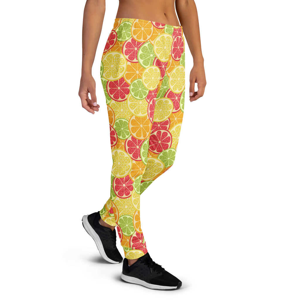 Women’s citrus slice recycled jogger pants with pockets featuring bright yellow green and pink citrus pattern and cozy fleece lining