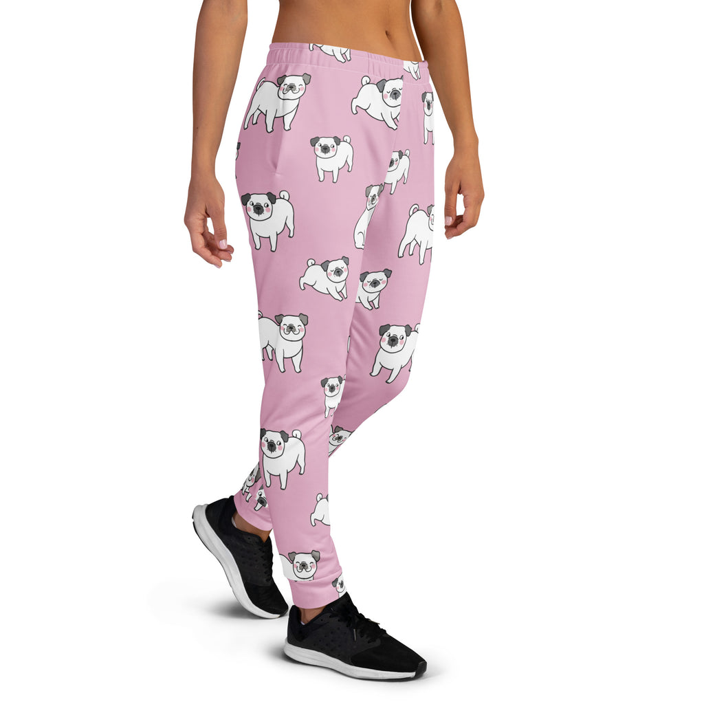 Women’s pink recycled jogger pants with cozy brushed fleece inside and playful white cartoon pug pattern with pockets