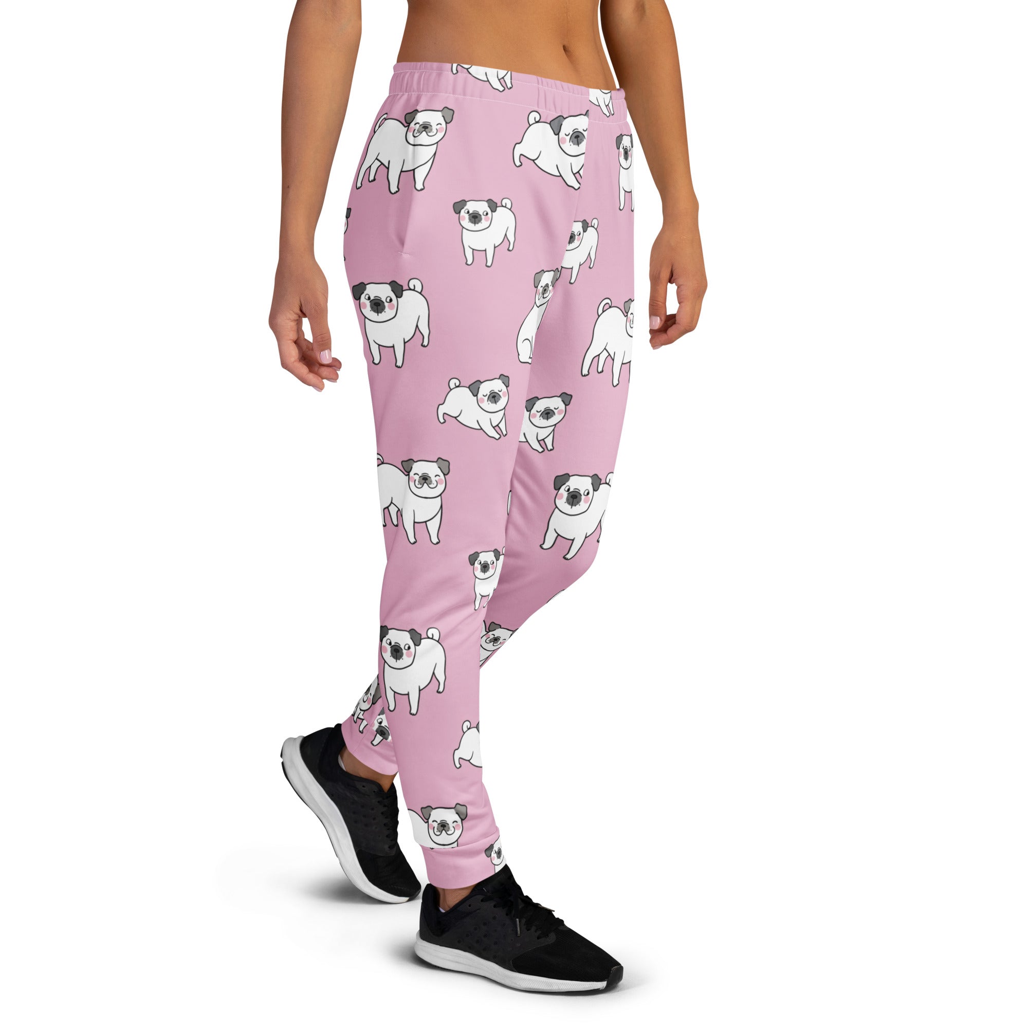 Women’s pink recycled jogger pants with cozy brushed fleece inside and playful white cartoon pug pattern with pockets
