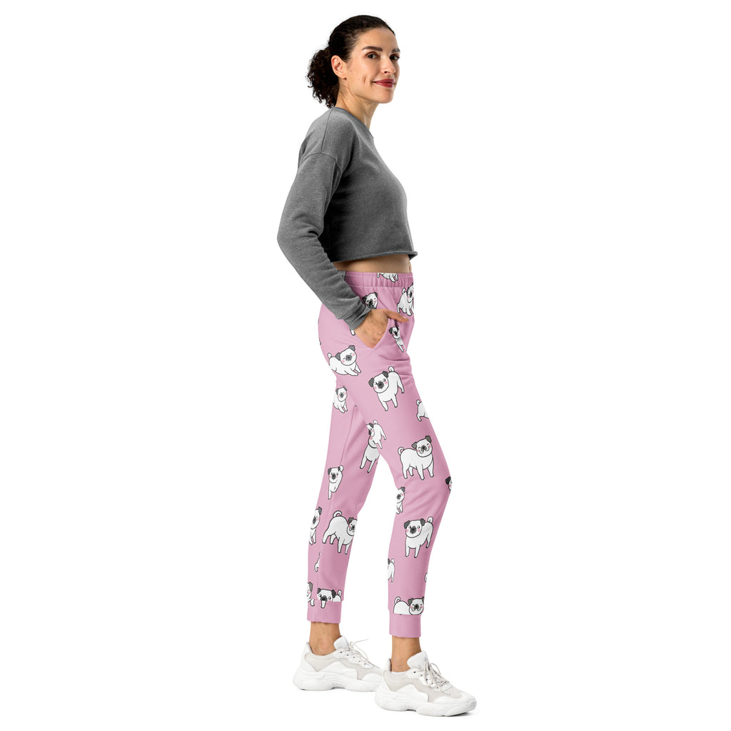 Women’s pink recycled jogger pants with pockets featuring playful white pug illustrations and cozy brushed fleece inside