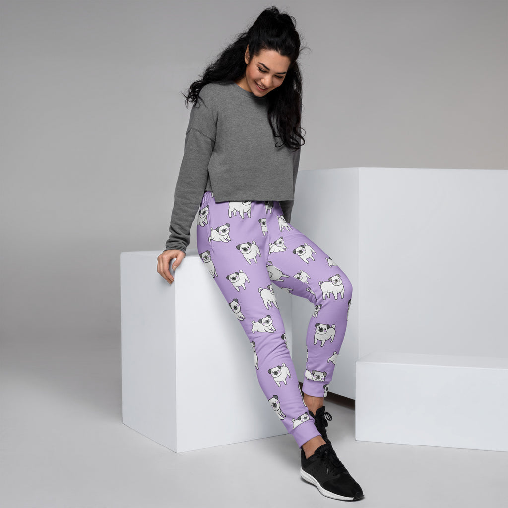 Women’s purple recycled jogger pants with pockets featuring a playful white pug pattern and cozy brushed fleece inside
