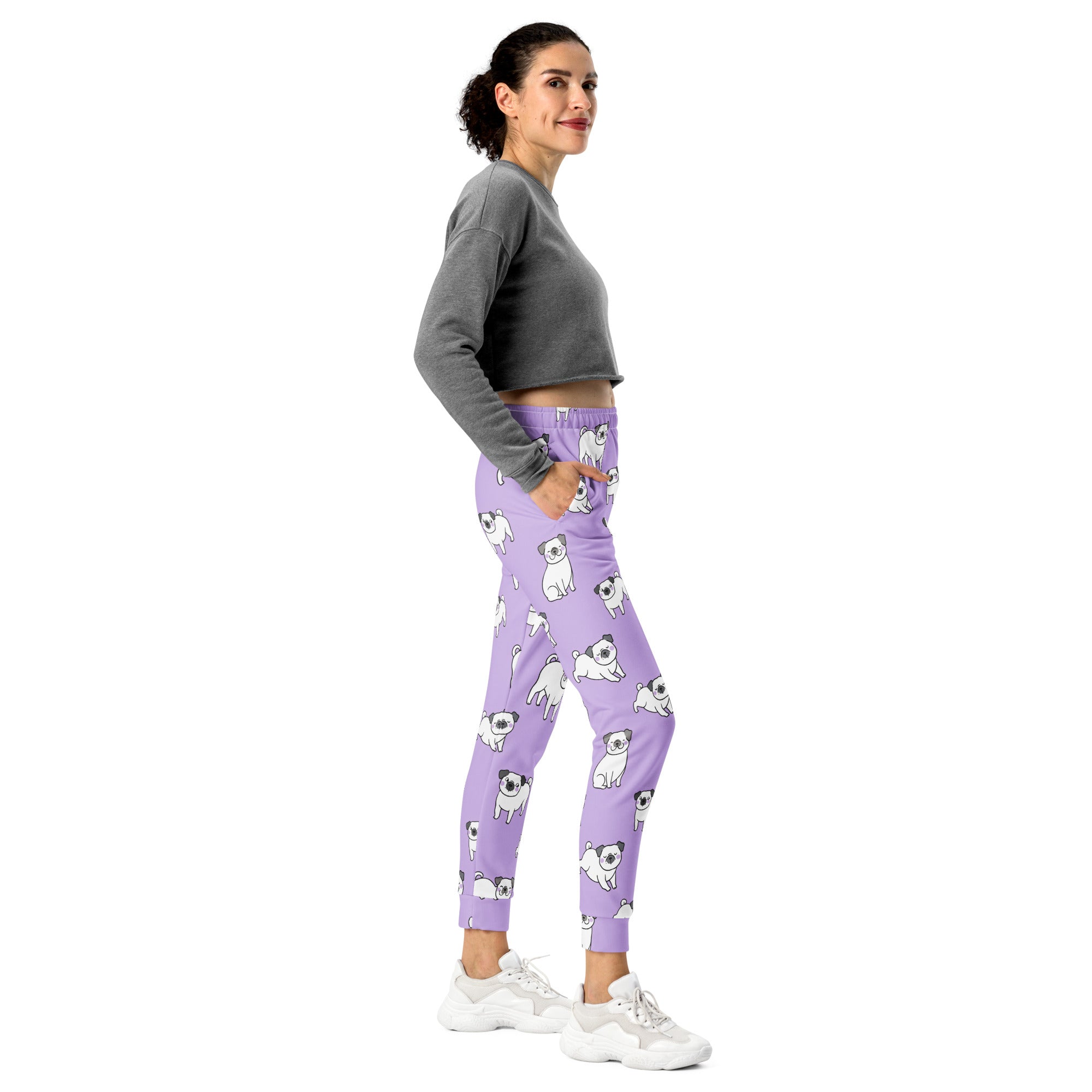 Women’s purple recycled jogger pants with pockets featuring a playful white pug pattern and cozy brushed fleece inside