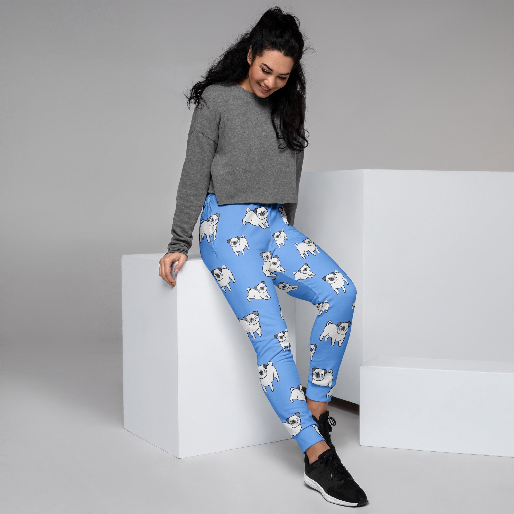 Women’s light blue recycled jogger pants with cozy fleece lining and white pug illustrations with pockets