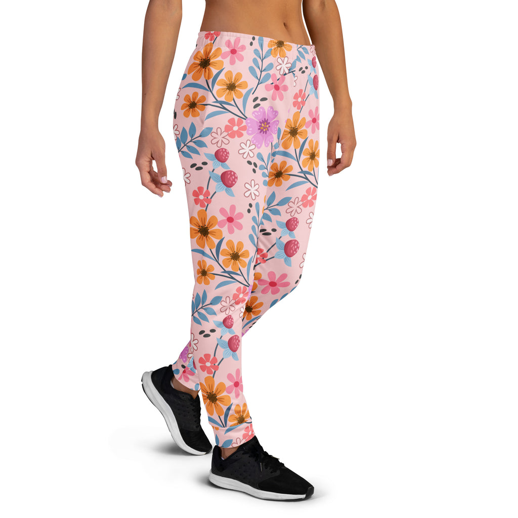 Women’s pink floral recycled jogger pants with pockets featuring vibrant orange purple white flowers and blue leaves