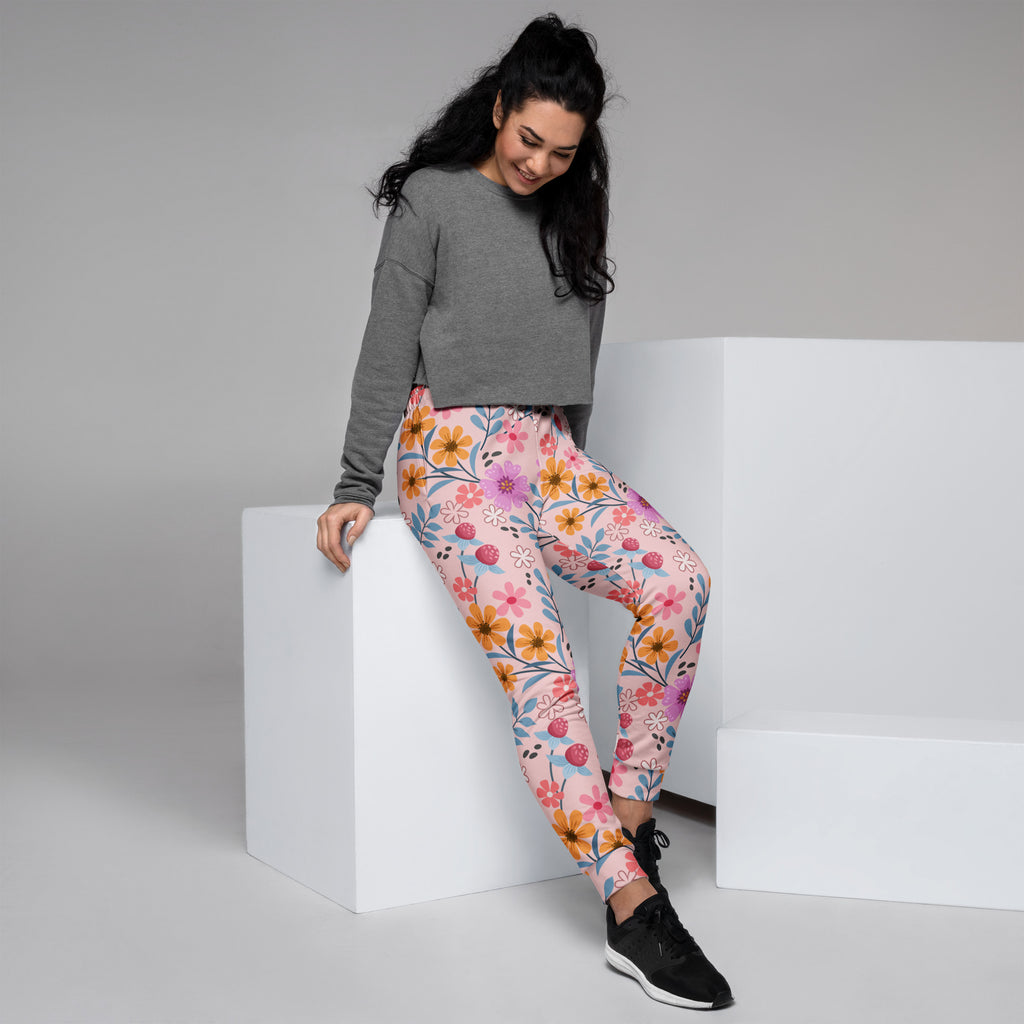 Women’s pink floral recycled jogger pants with vibrant orange yellow and purple flowers and cozy brushed fleece lining