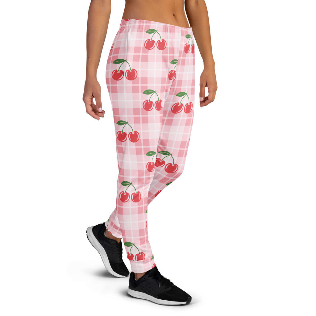 Women’s pink cherry plaid recycled jogger pants with pockets featuring red cherry pattern and cozy brushed fleece inside