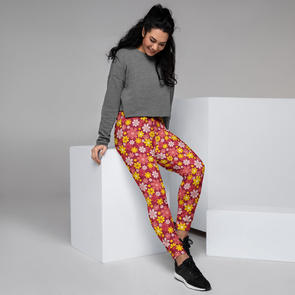 Women’s red floral recycled jogger pants with vibrant pink and yellow floral pattern cozy brushed fleece lining