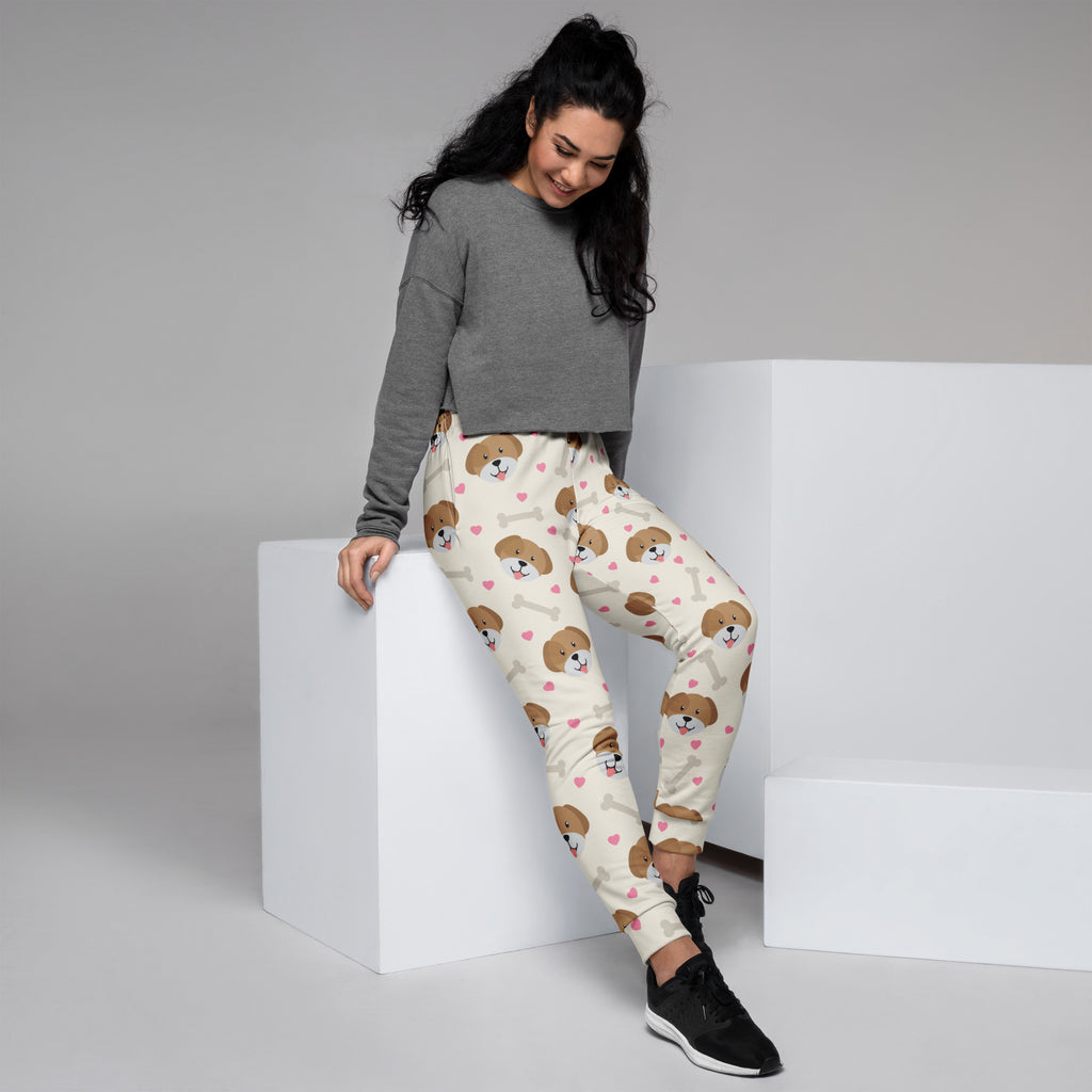 Cream-colored women’s jogger pants with brown puppy faces pink hearts white bones cozy brushed inside fleece