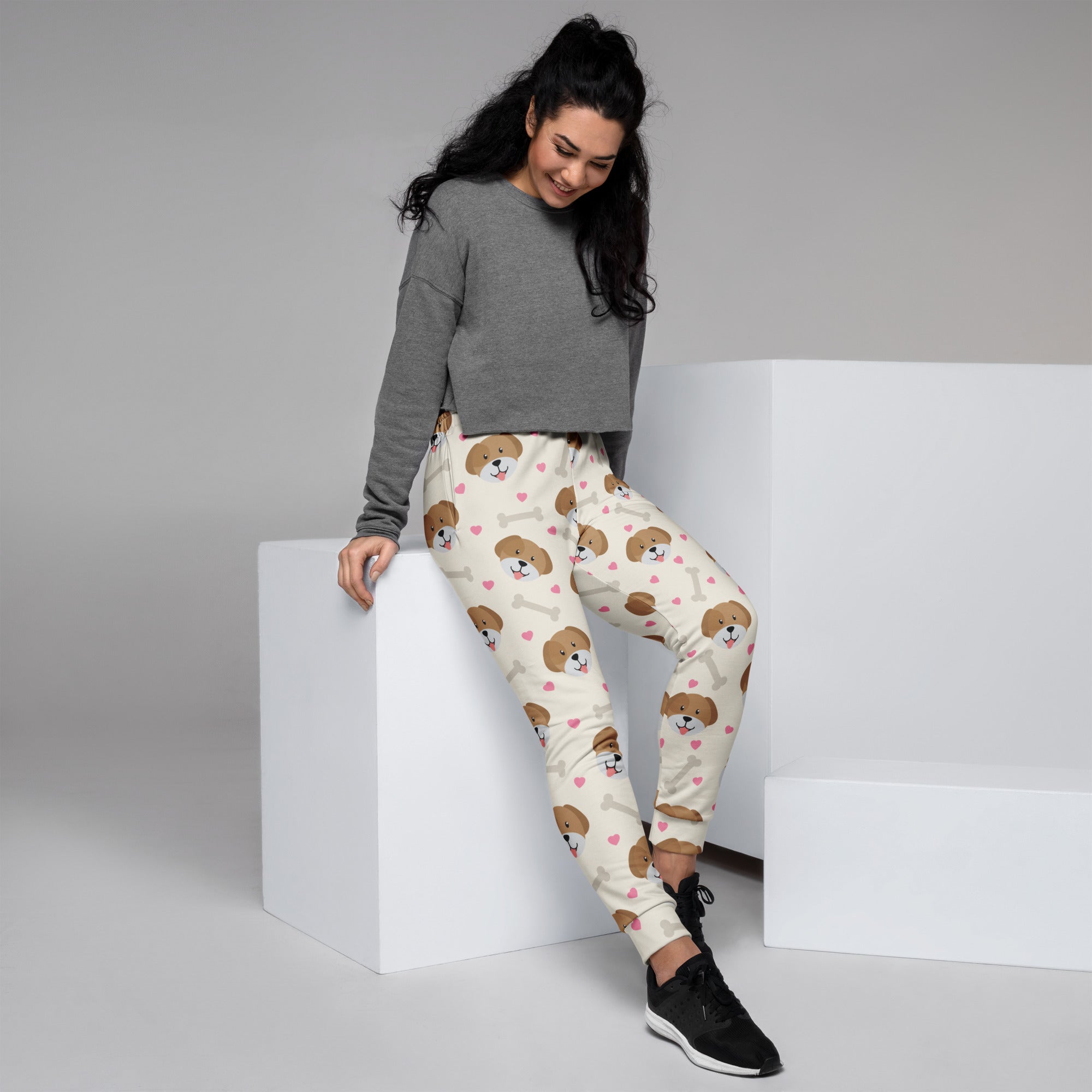 Cream-colored women’s jogger pants with brown puppy faces pink hearts white bones cozy brushed inside fleece