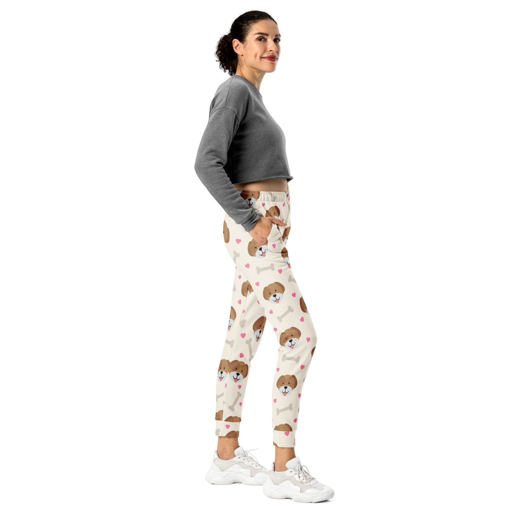 Women’s cream-colored recycled jogger pants with brown puppy faces pink hearts white bones cozy brushed fleece