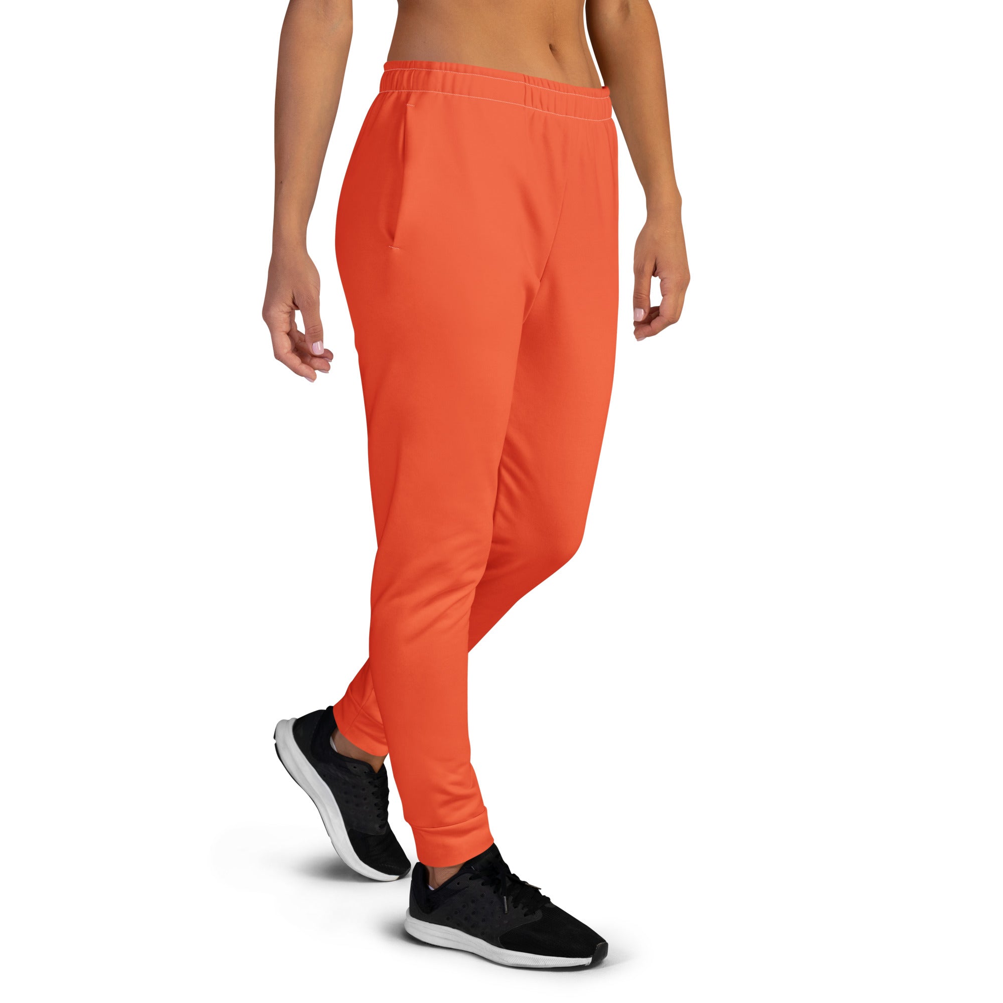 Women’s orange recycled jogger pants with pockets featuring a relaxed fit and cozy brushed inside fleece