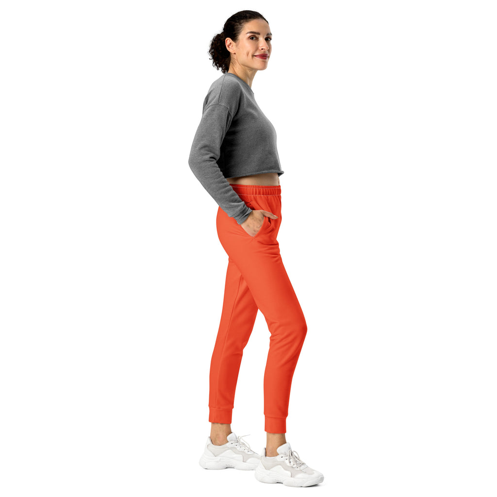 Women’s bright orange recycled jogger pants with comfortable elastic waistband tapered legs and cozy brushed fleece inside
