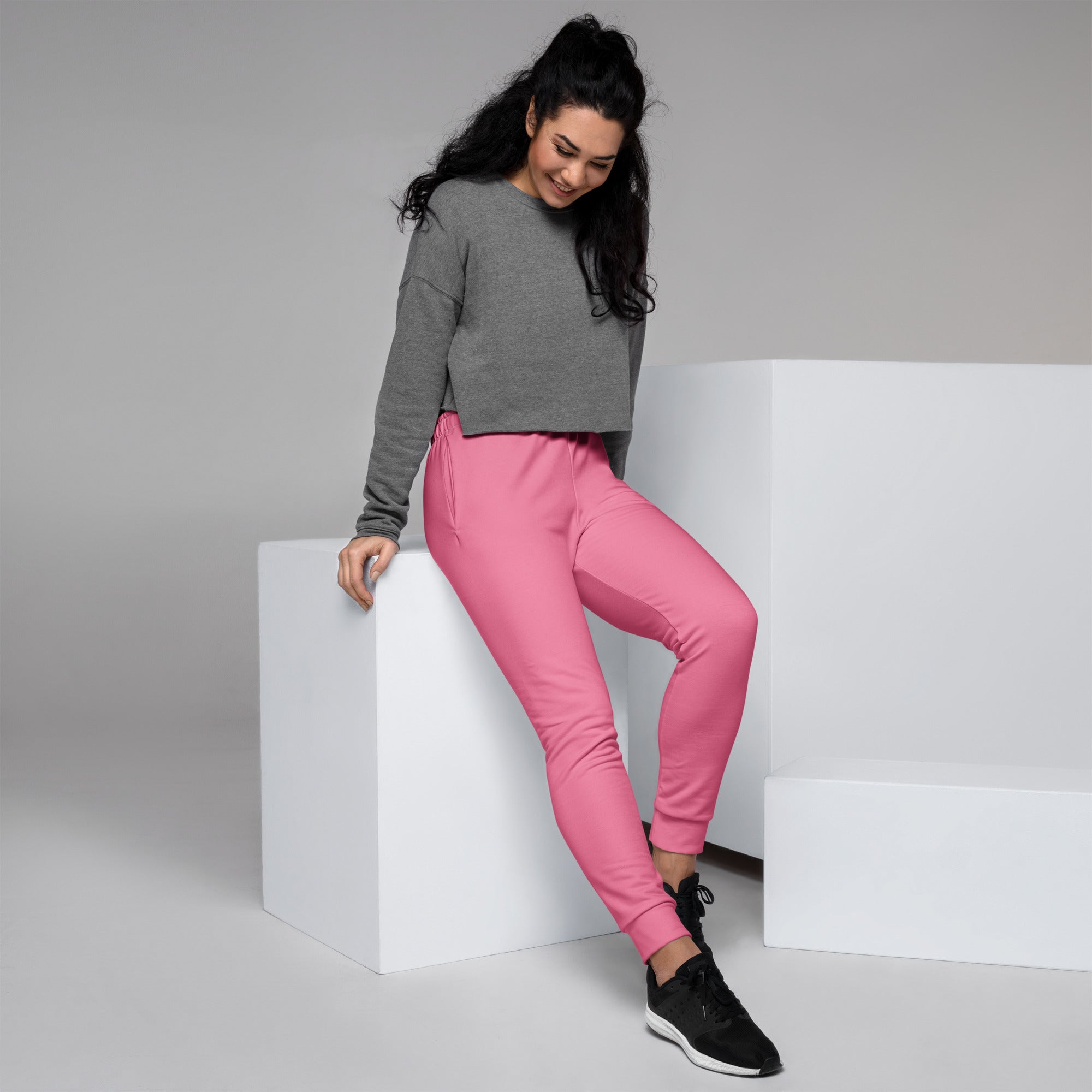 Women’s pink recycled jogger pants with snug fit elastic cuffs pockets and cozy brushed inside fleece lining