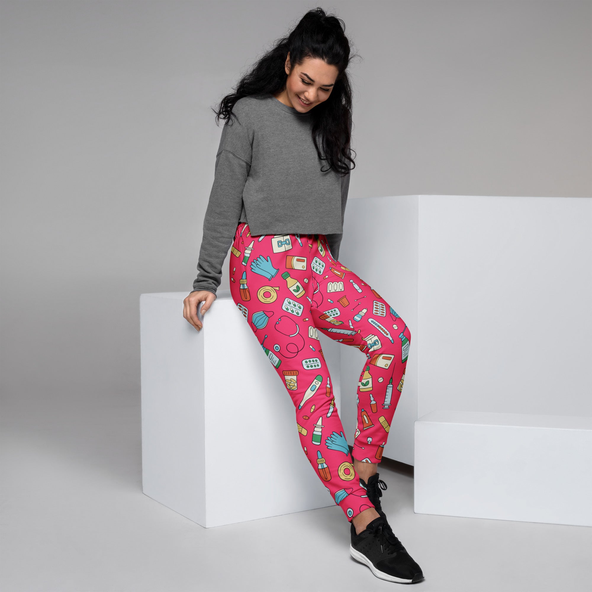 Women’s bright pink medical print recycled jogger pants with pockets and cozy brushed fleece inside featuring health icons
