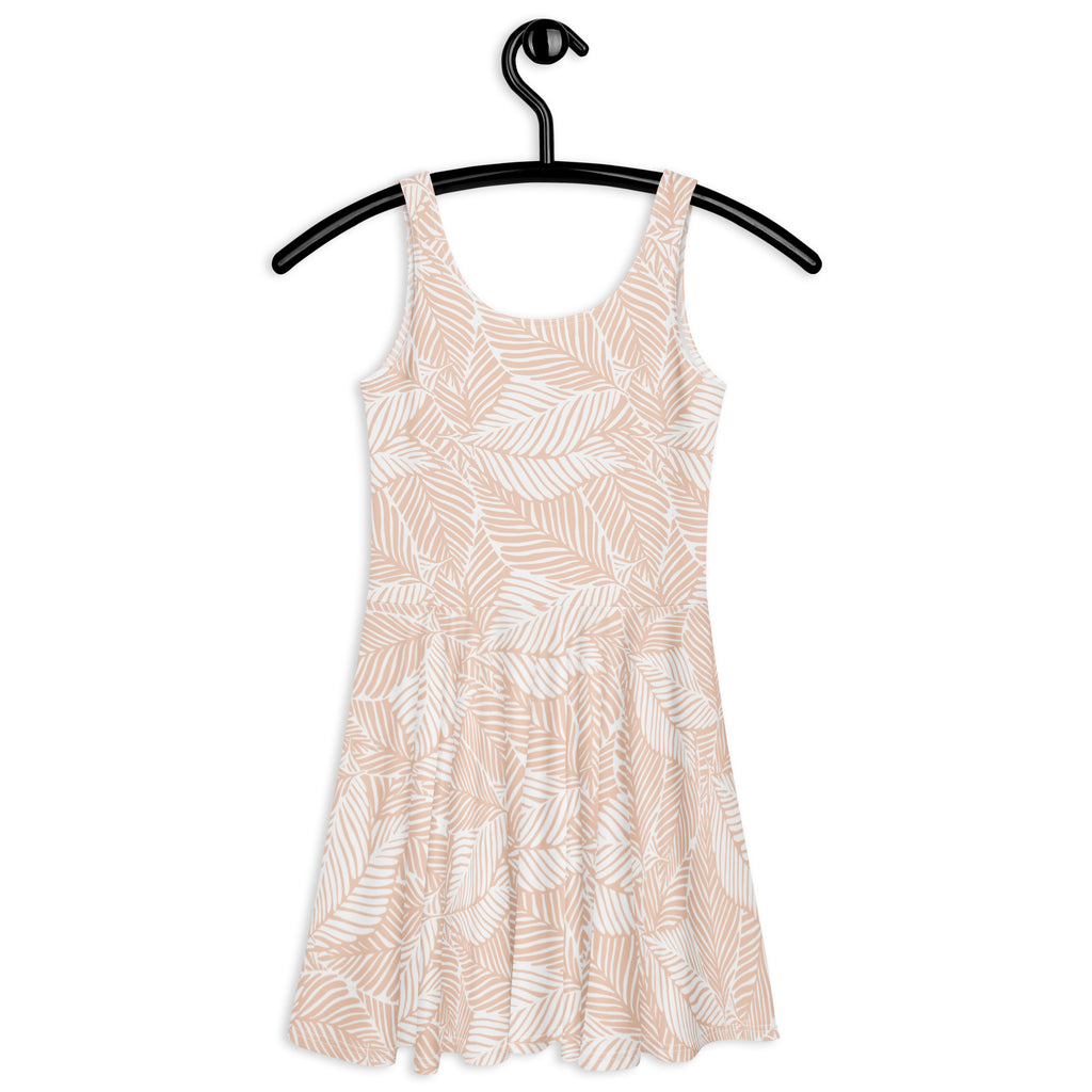A soft blush pink sleeveless women’s skater dress with white leaf print made of buttery soft fabric with UPF 50+