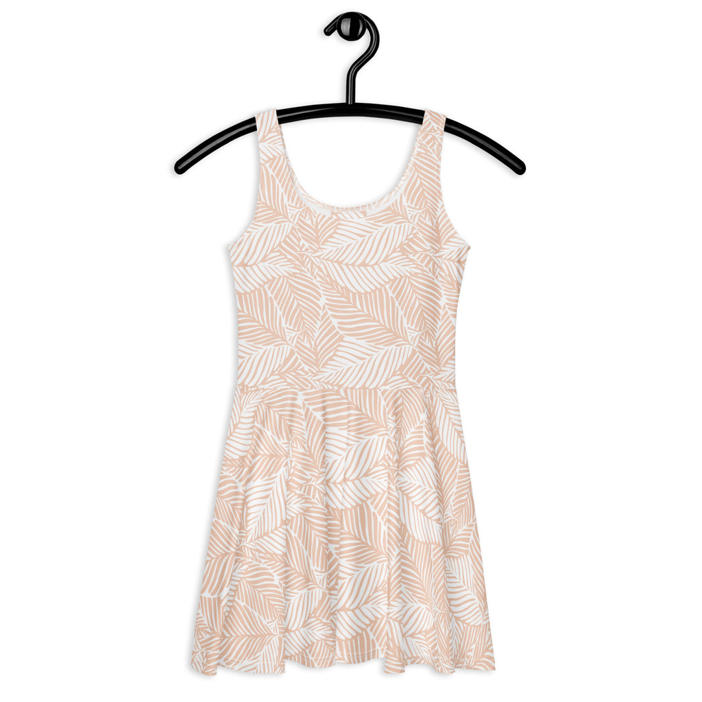 A soft blush neutral sleeveless skater dress with white and beige leaf print made from buttery soft fabric with UPF 50+