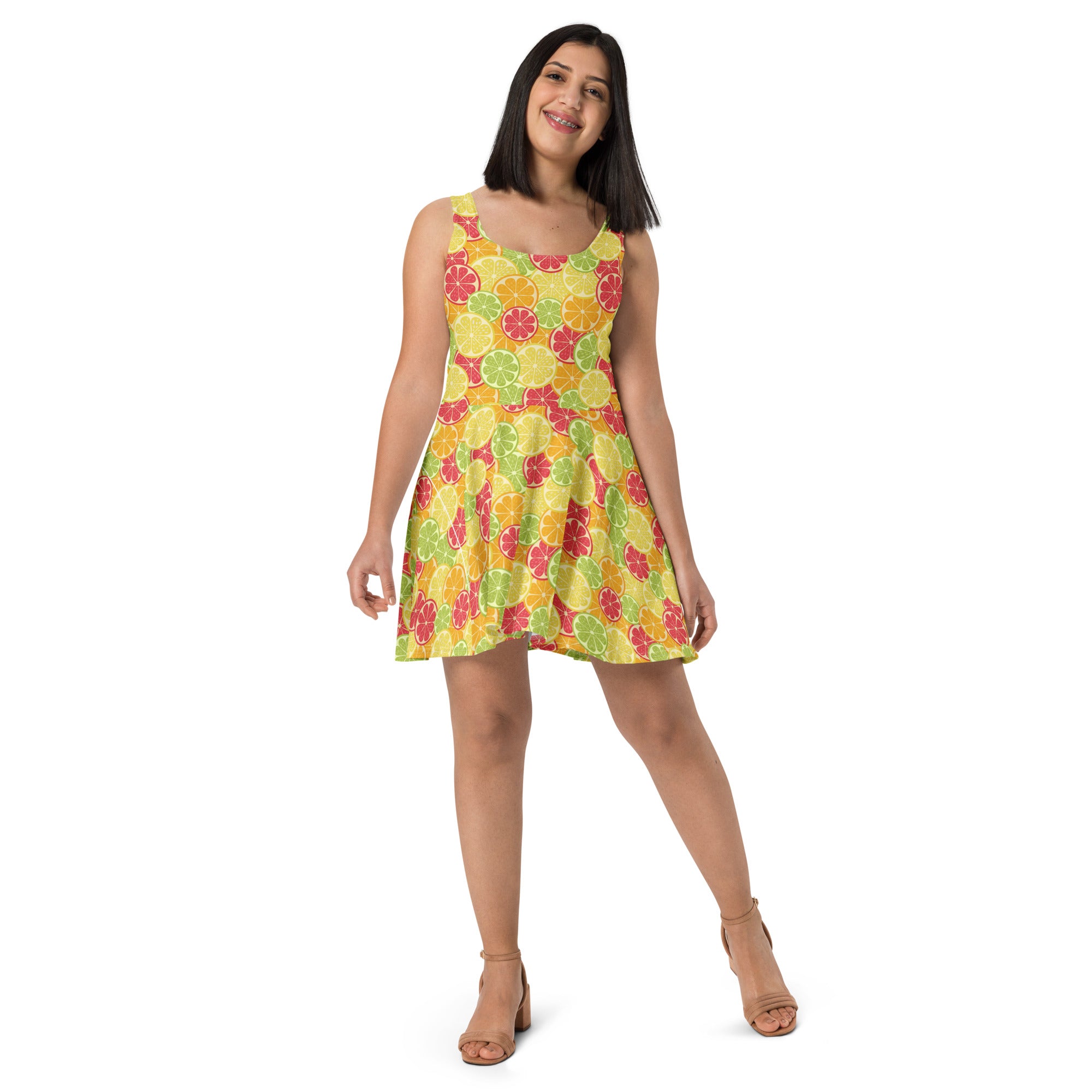 A vibrant yellow sleeveless buttery soft skater dress with sliced citrus fruit pattern and UPF 50 plus protection