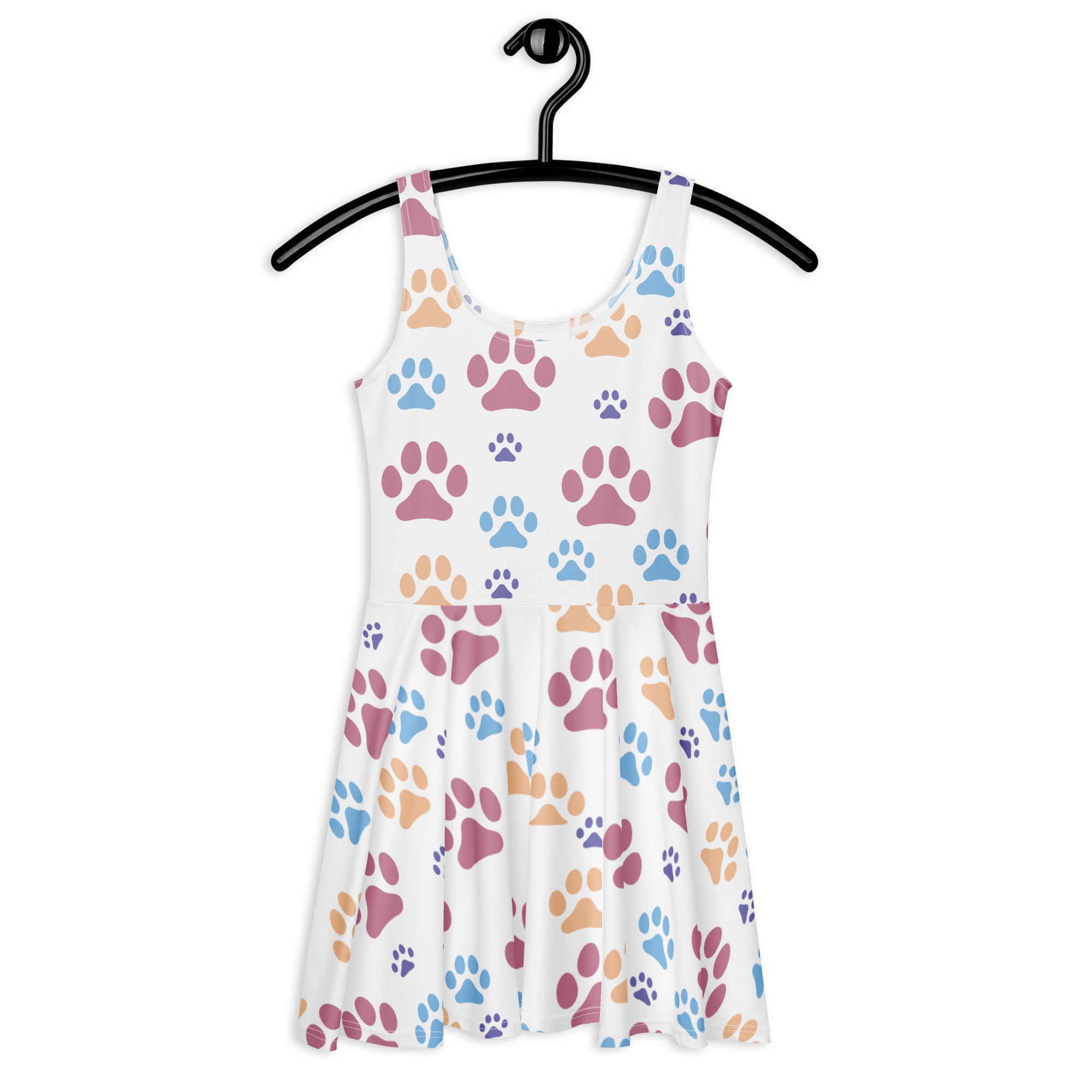 A white sleeveless buttery soft skater dress with colorful pink blue and tan paw prints and upf 50 plus protection