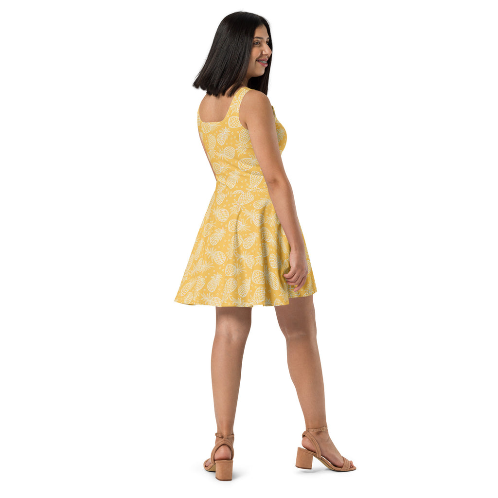 Women’s yellow sleeveless skater dress with subtle white pineapple pattern and buttery soft fabric with UPF 50 plus protection