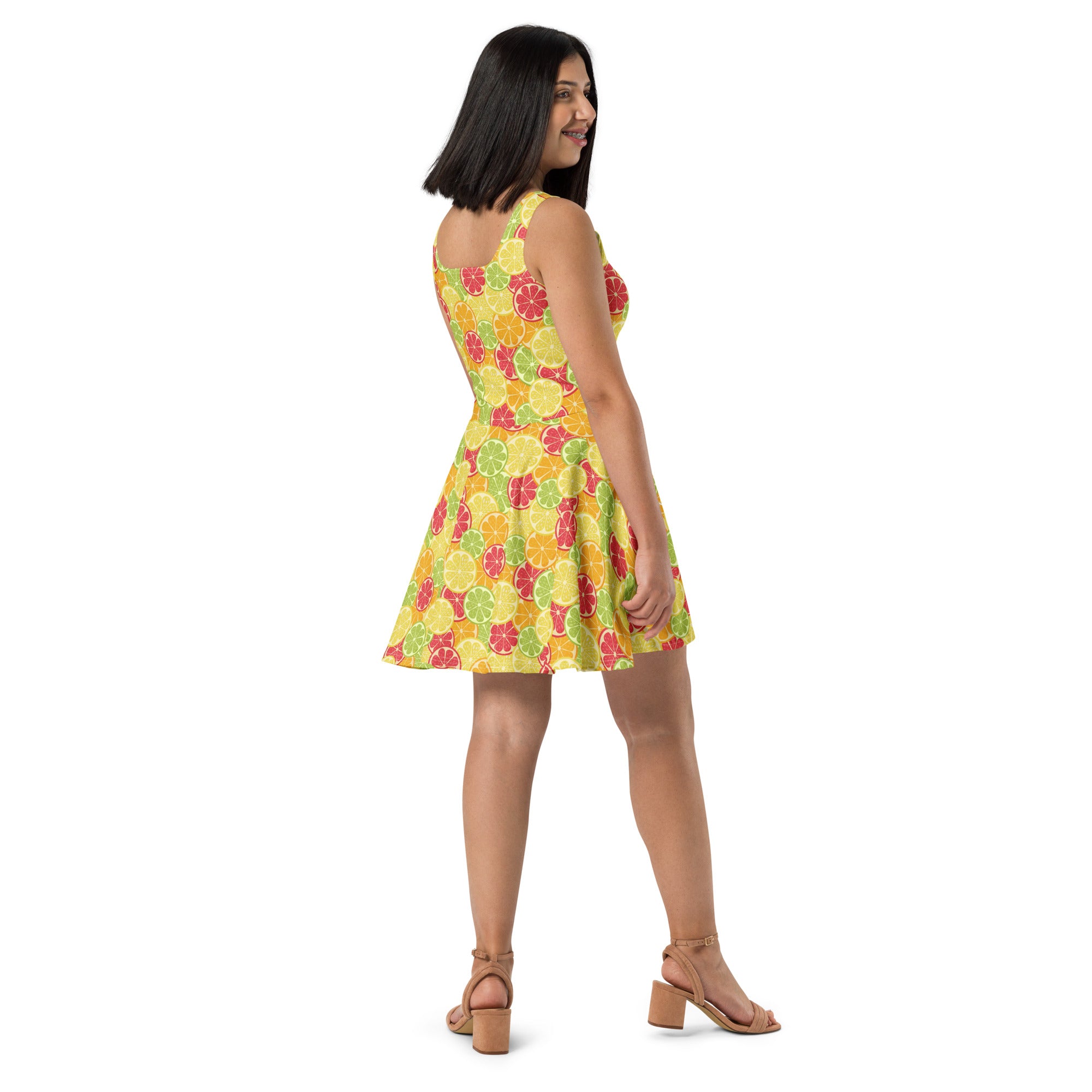 A vibrant yellow sleeveless buttery soft skater dress with a citrus fruit pattern and UPF 50 plus sun protection