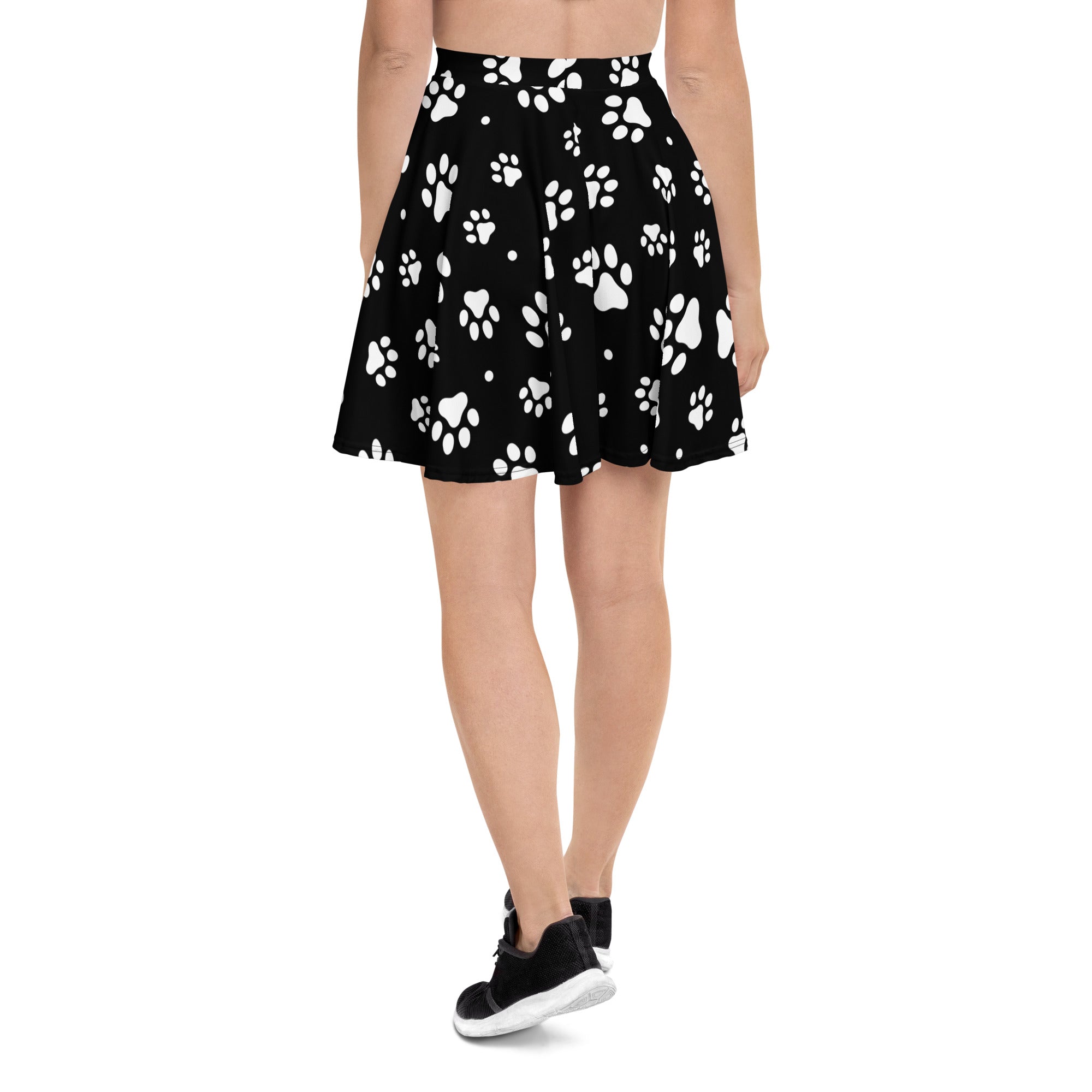 Black pleated women’s paw print skater skirt with white prints, flowy high waisted made from recycled fabric with UPF 50+