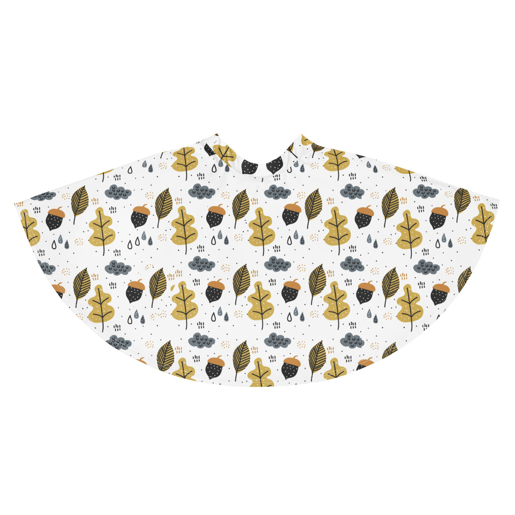 A white rain poncho with a playful gold and black leaf acorn cloud pattern designed for autumn outdoor use