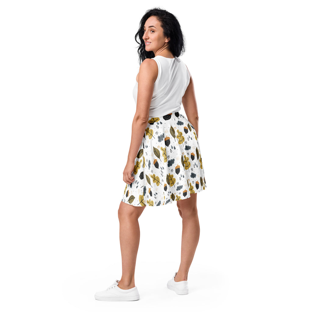 Women’s autumn themed white pleated skater skirt with gold and black leaf acorn print made from recycled fabric