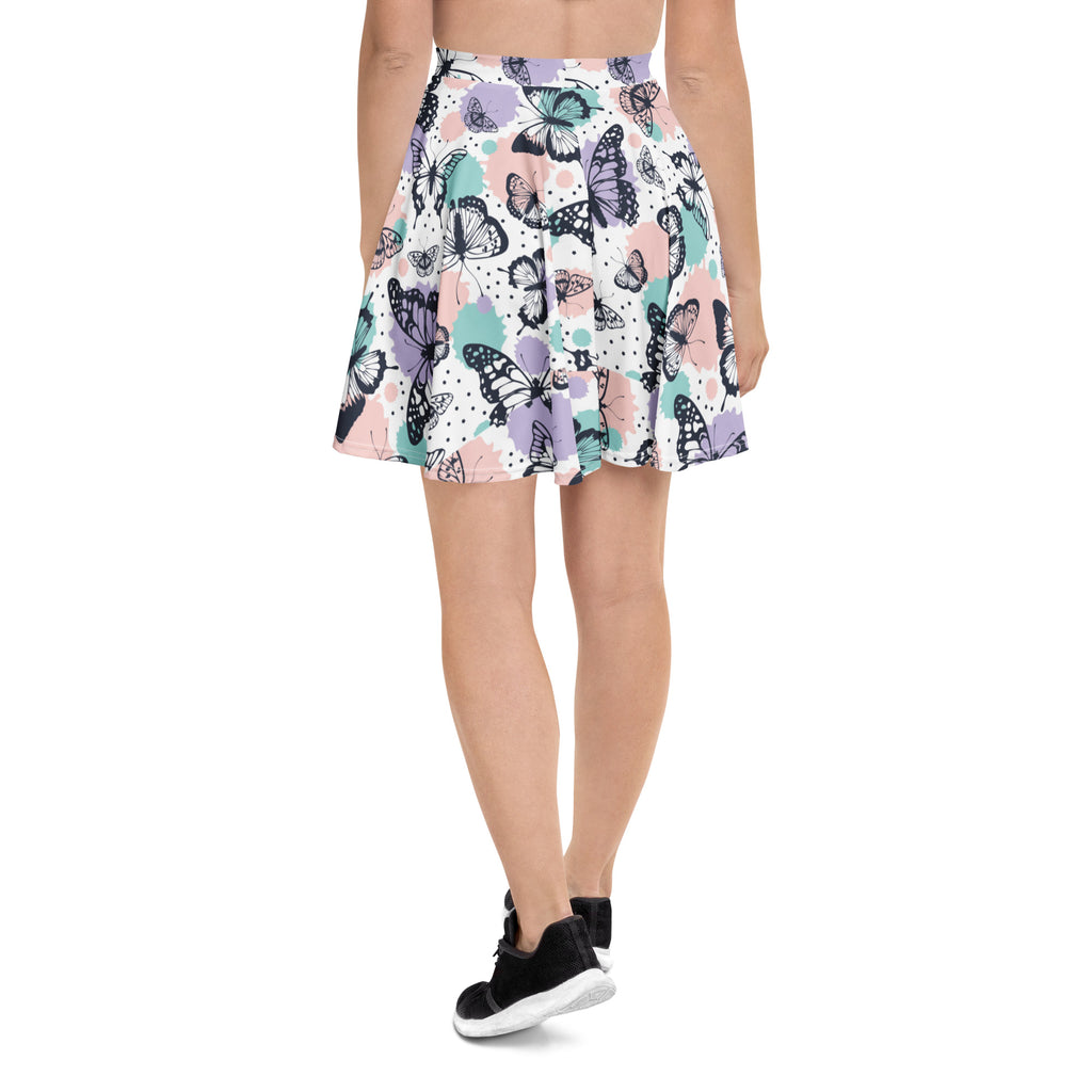 Women’s pastel butterfly skater skirt with vibrant black purple teal butterfly pattern on soft pastel recycled fabric