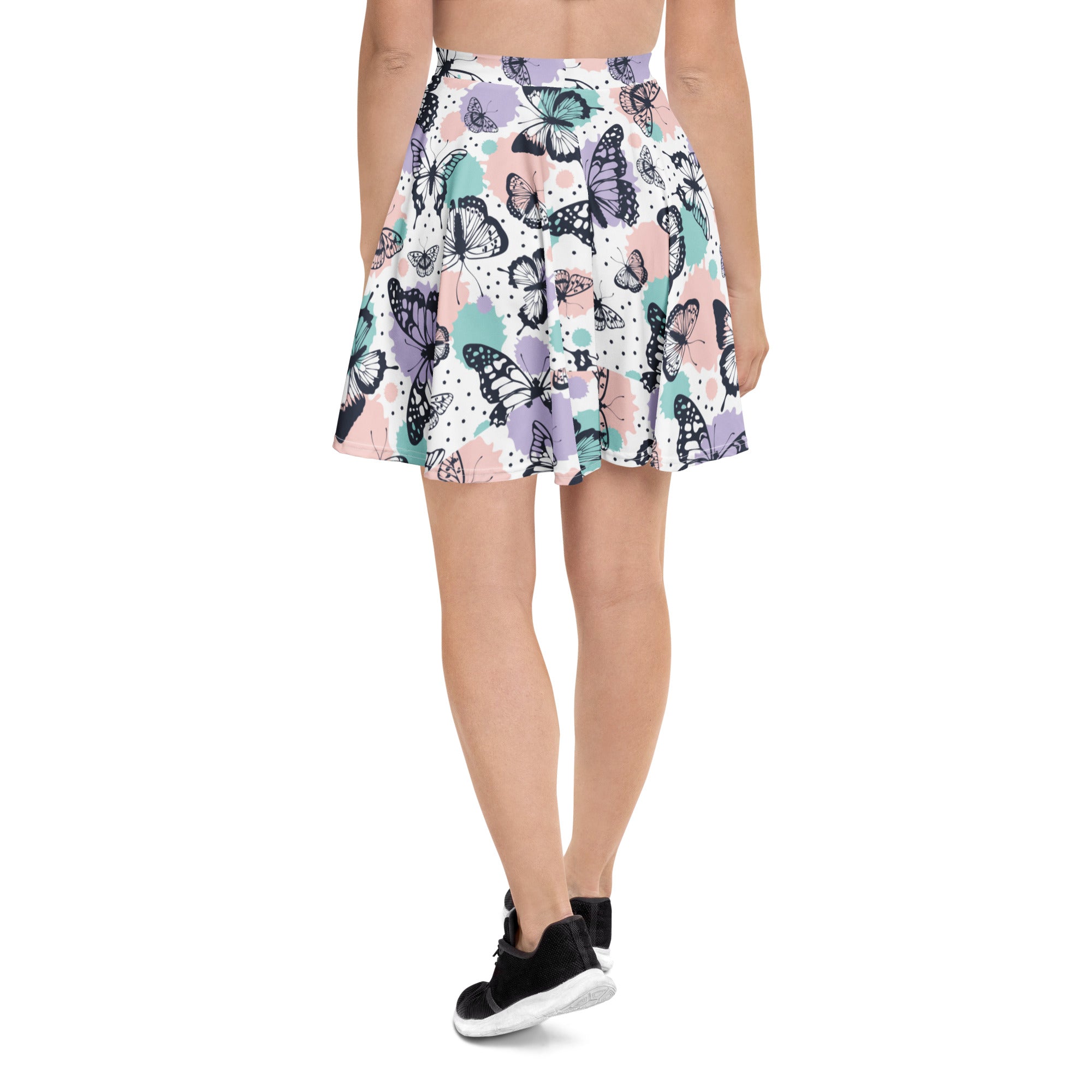 Women’s pastel butterfly skater skirt with vibrant black purple teal butterfly pattern on soft pastel recycled fabric