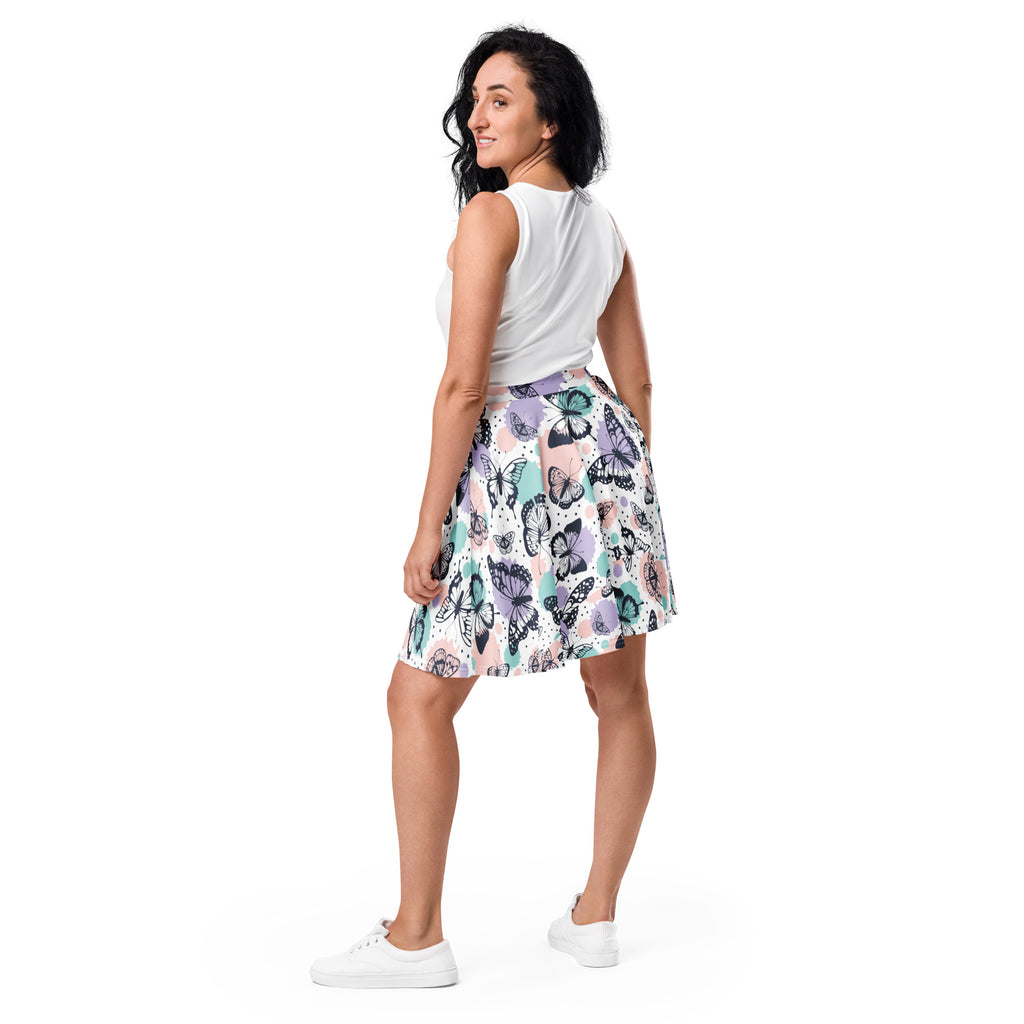 Women’s pastel butterfly skater skirt with vibrant purple teal black pattern on soft pastel recycled fabric with upf 50+