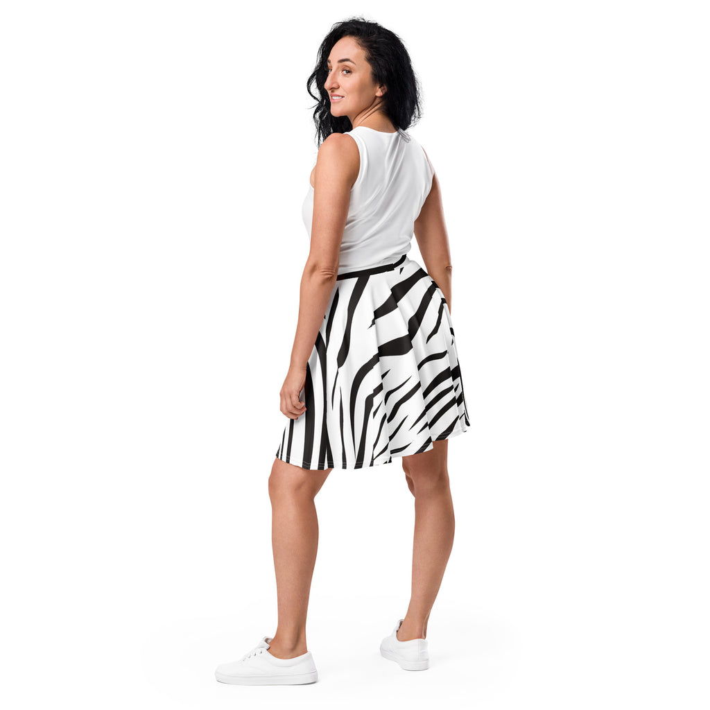 A woman wearing a black and white zebra print flared skater skirt made from recycled fabric with UPF 50 plus protection