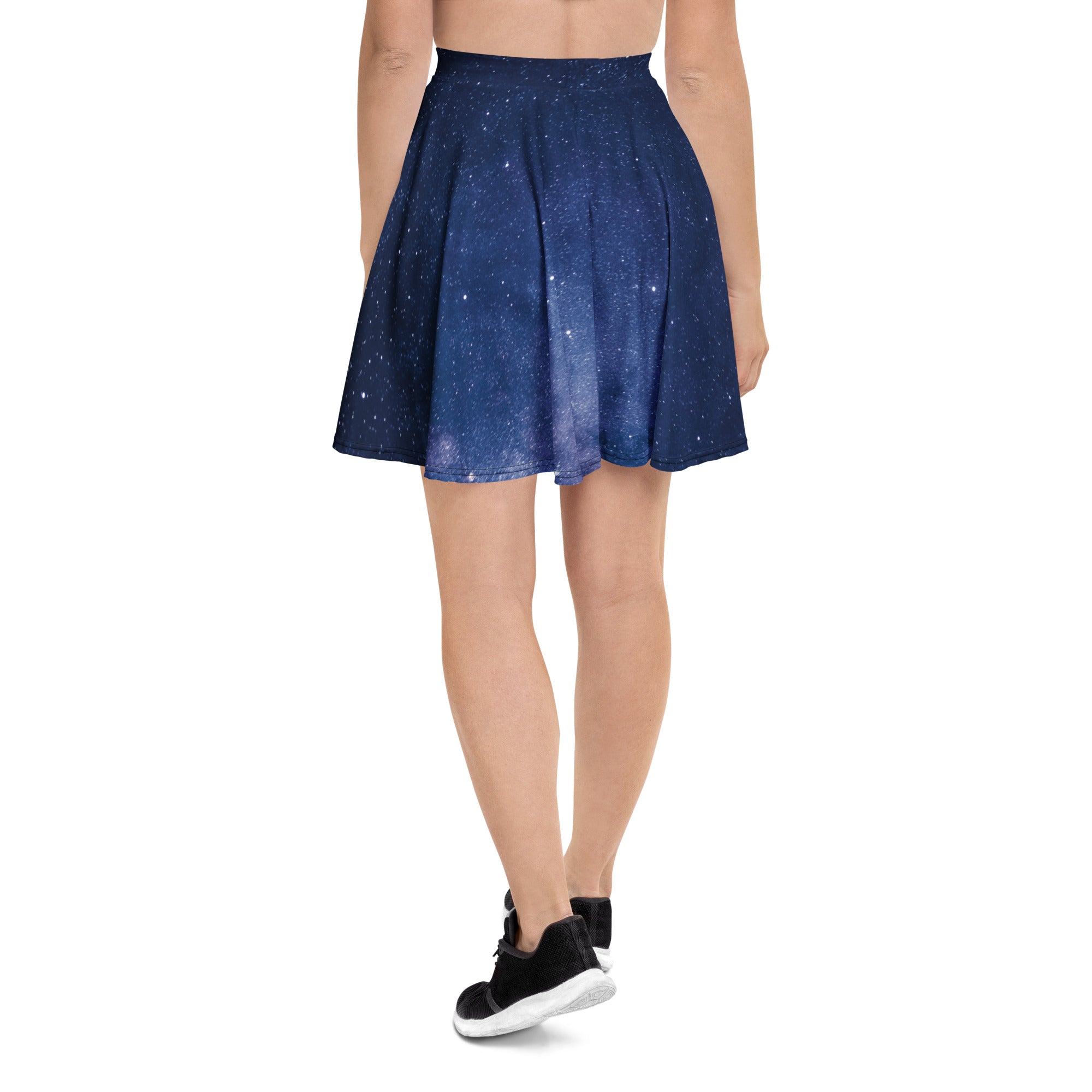 A navy blue pleated women’s galaxy skater skirt with starry night print made from recycled fabric with UPF 50+ protection