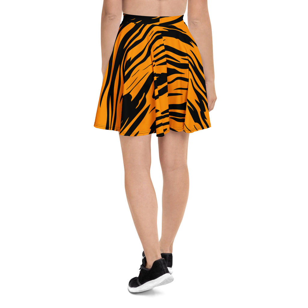 A vibrant orange and black tiger stripe pleated skater skirt with flowy high waist made from recycled fabric and UPF 50+ protection
