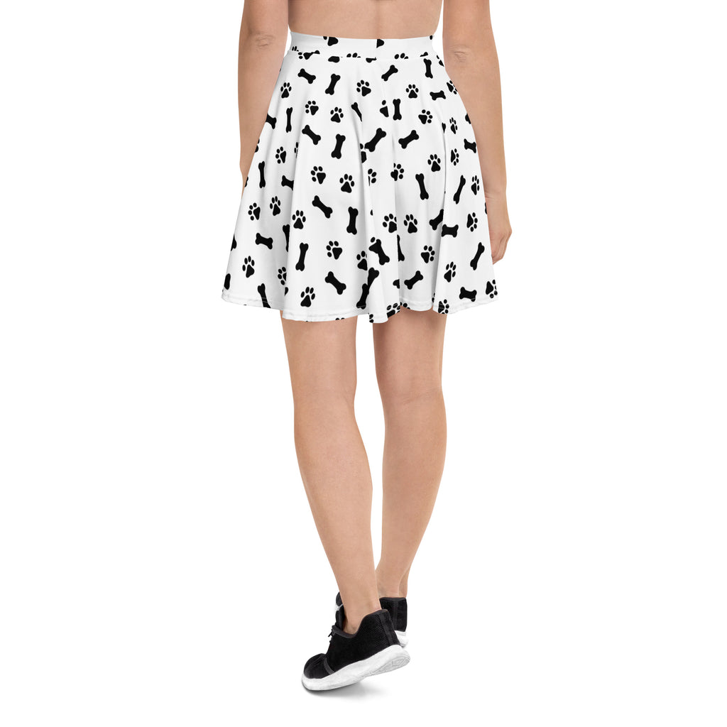 White pleated women’s skater skirt with black dog bone and paw print pattern made from recycled fabric with upf 50+