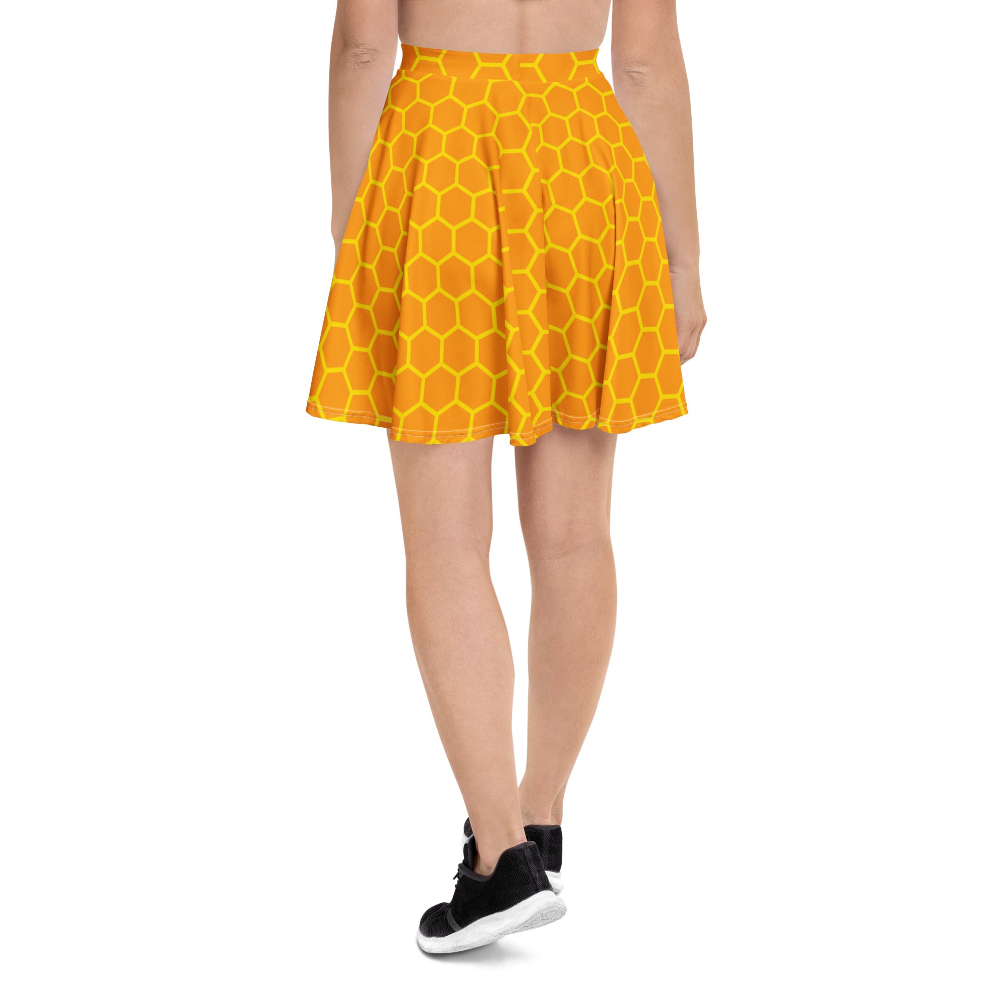 A vibrant yellow honeycomb patterned women’s honeycomb skater skirt made with recycled fabric and UPF 50+ protection