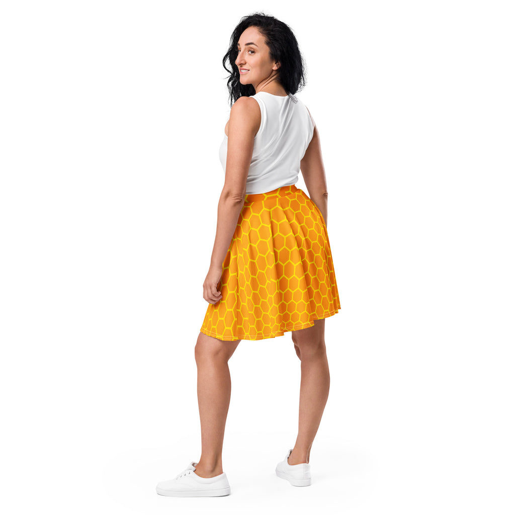 A vibrant yellow honeycomb patterned women’s honeycomb skater skirt made from recycled fabric with upf 50+ protection
