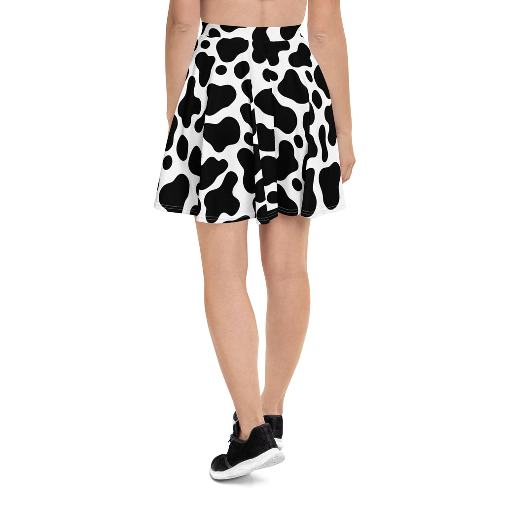Women’s cow print skater skirt in black and white pleated design made from recycled fabric with UPF 50+ protection