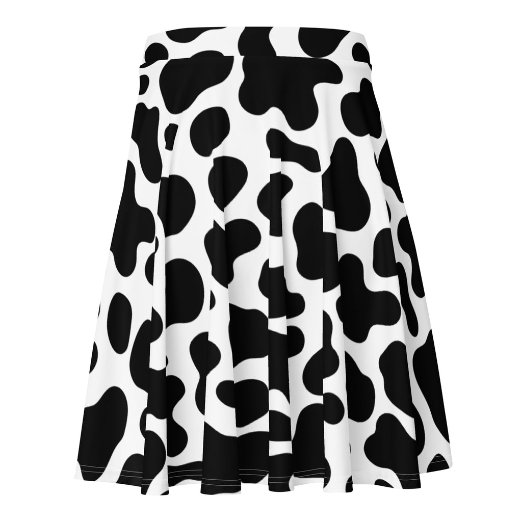 A pleated women’s cow print skater skirt in black and white made from recycled fabric with UPF 50 plus protection