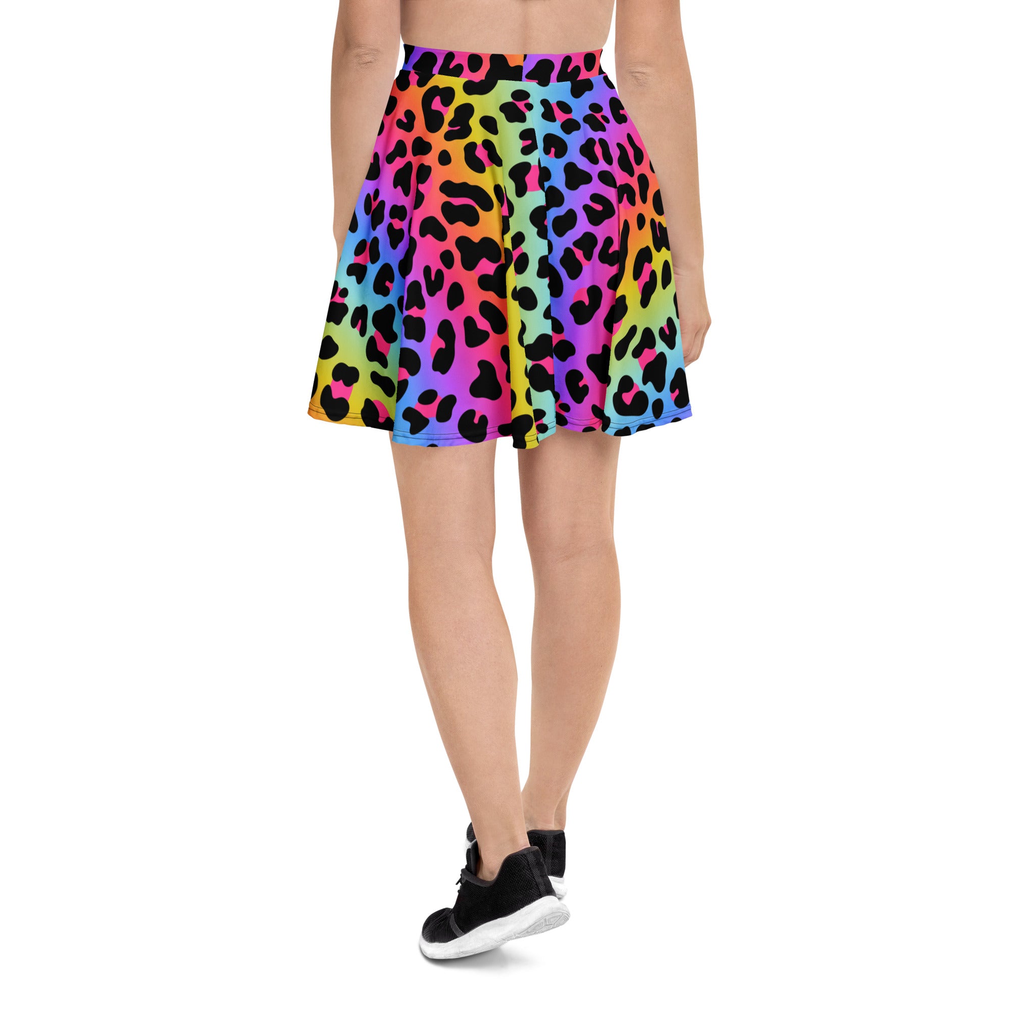 A vibrant rainbow leopard skater skirt with pleats high waisted flowy recycled fabric and upf 50 plus protection