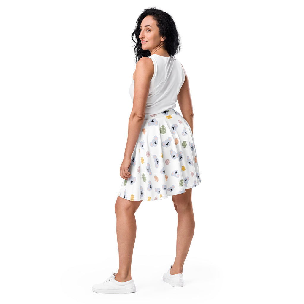 White pleated skater skirt with koala and tropical leaf pattern in pastel shades high waisted flowy recycled fabric upf 50+