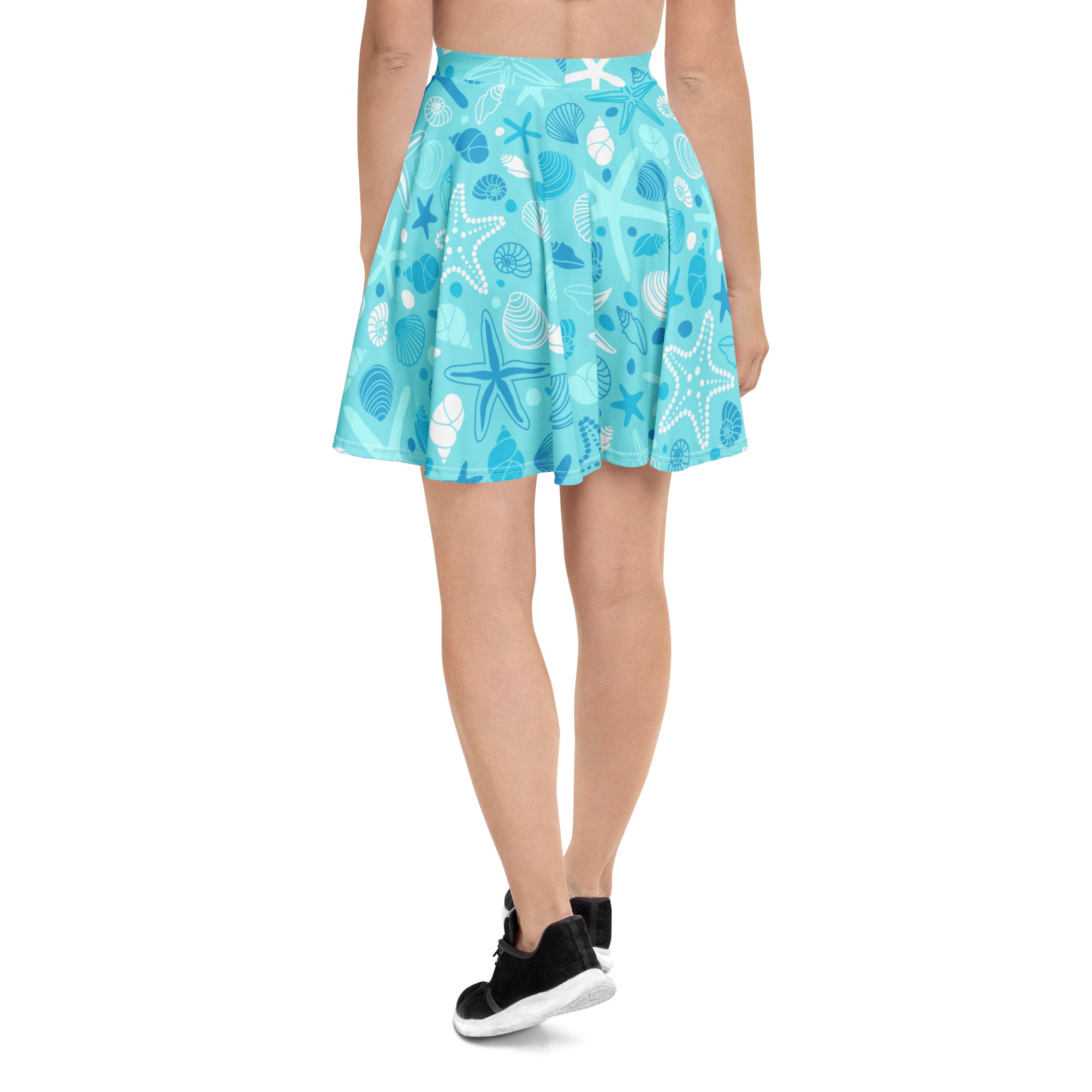 A light blue women’s starfish and shells skater skirt with pleats flowy high waisted upf 50 plus recycled fabric