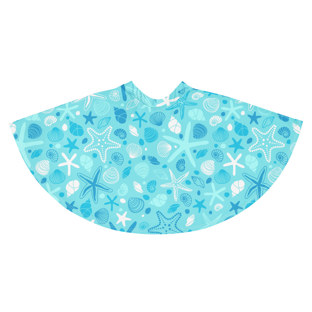 A light blue beach poncho with white and dark blue starfish and seashell pattern made from recycled fabric