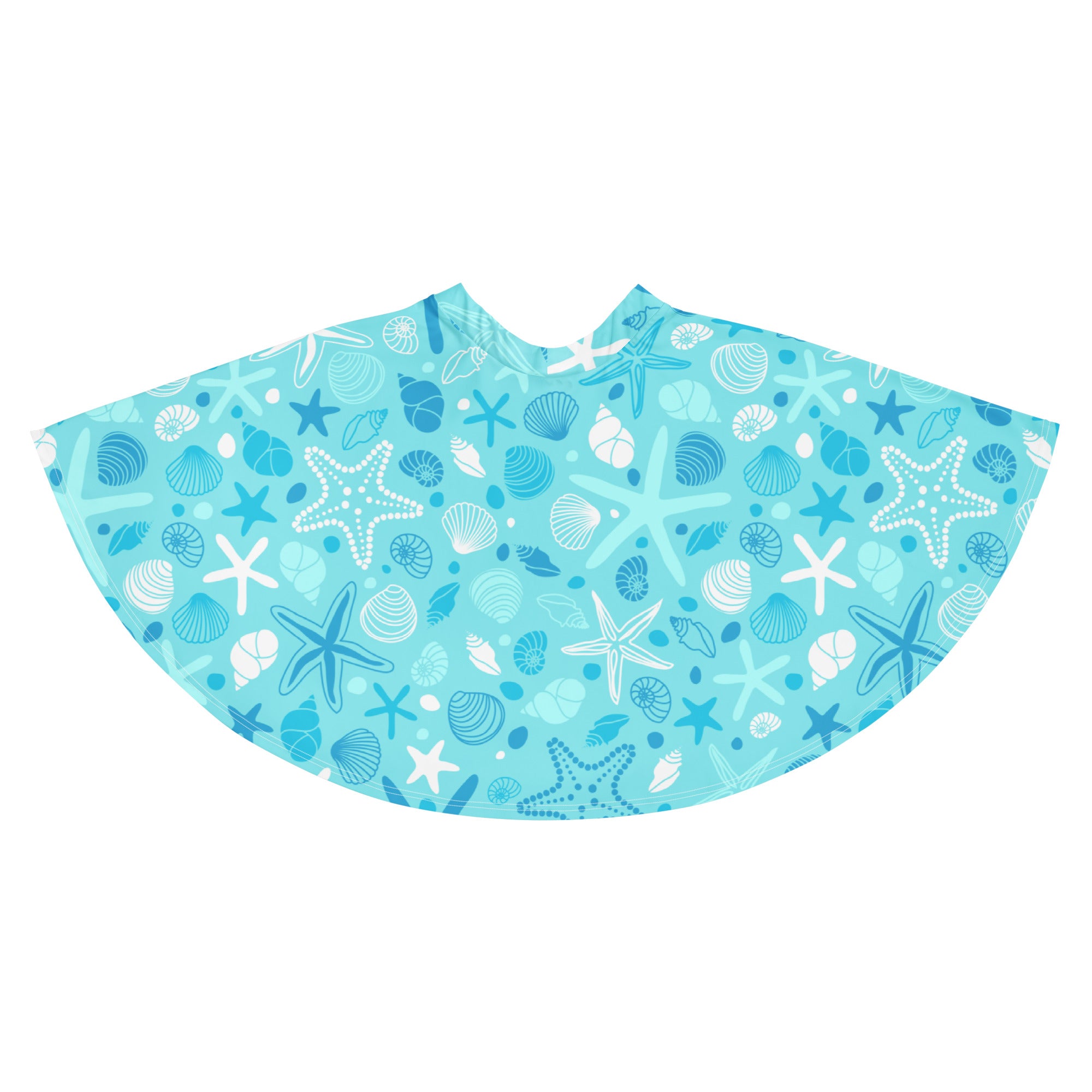 A light blue beach poncho with white and dark blue starfish and seashell pattern made from recycled fabric
