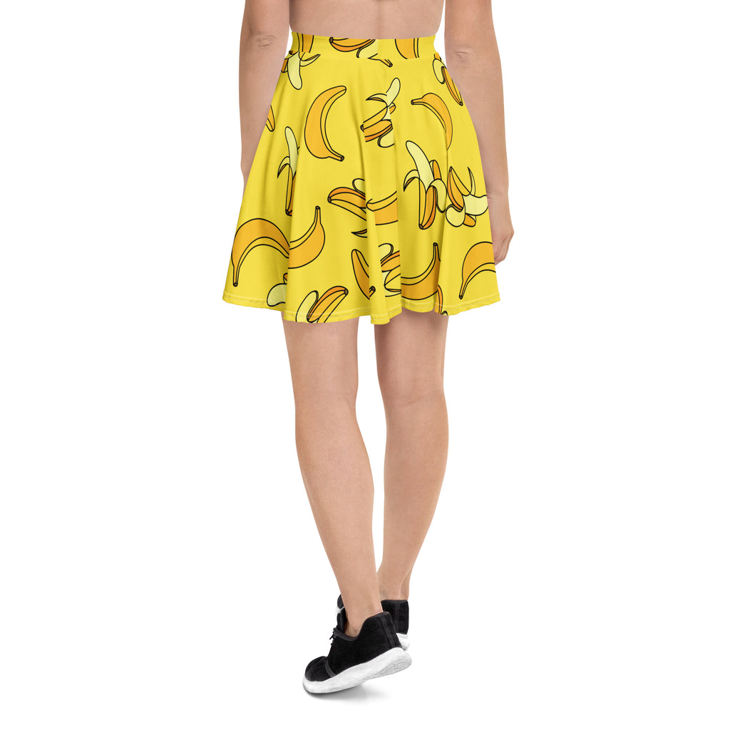 A vibrant yellow pleated skater skirt with cartoon banana pattern made from recycled fabric with upf 50 plus protection