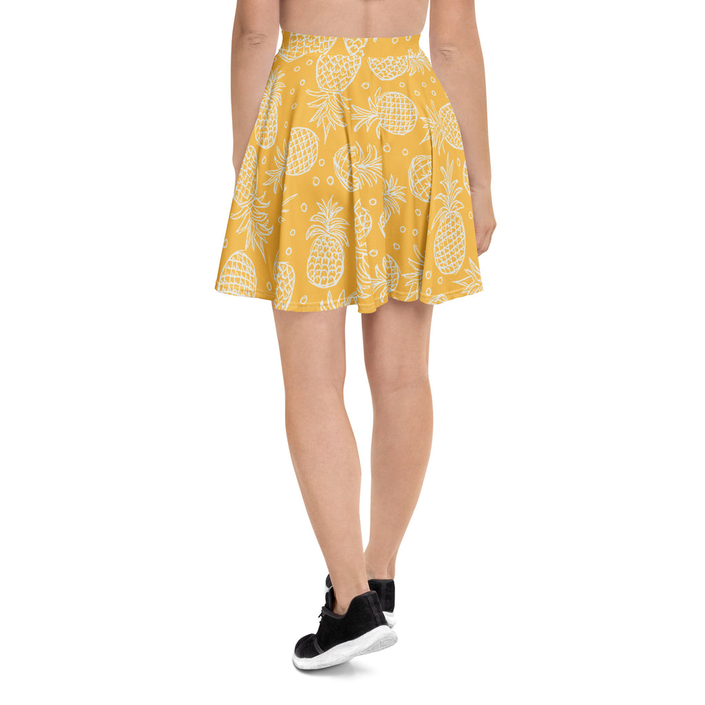 Yellow pleated skater skirt with white pineapple print made from recycled fabric featuring upf 50 plus protection