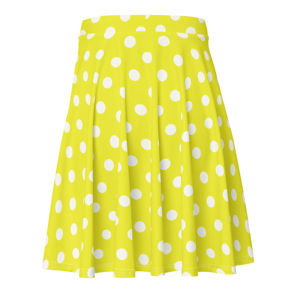 A vibrant yellow pleated women’s skater skirt with white polka dots made from recycled fabric with UPF 50+ protection