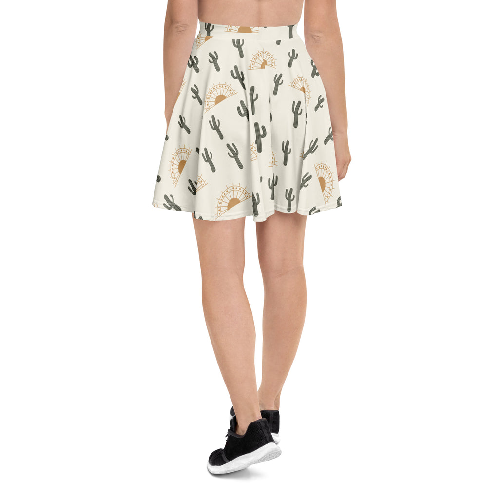 Women’s desert cactus sunrise skater skirt in off-white recycled fabric with black cacti and gold sunburst pattern