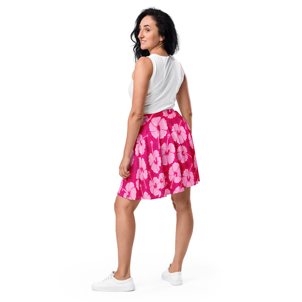 A vibrant pink women’s hibiscus skater skirt made from flowy recycled fabric with UPF 50 plus sun protection