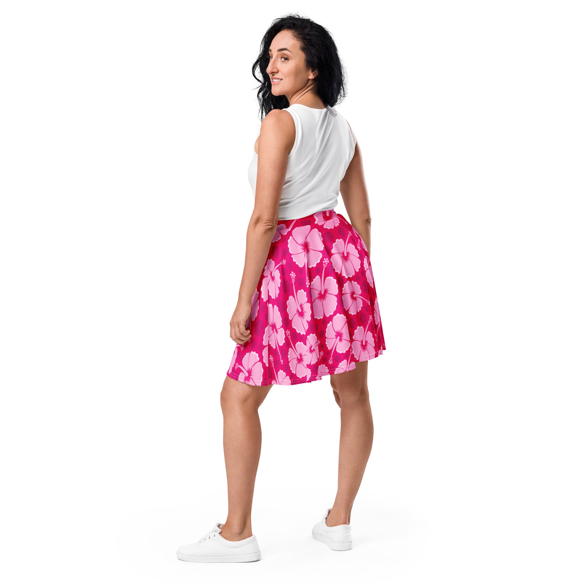 A vibrant pink women’s hibiscus skater skirt made from flowy recycled fabric with UPF 50 plus sun protection