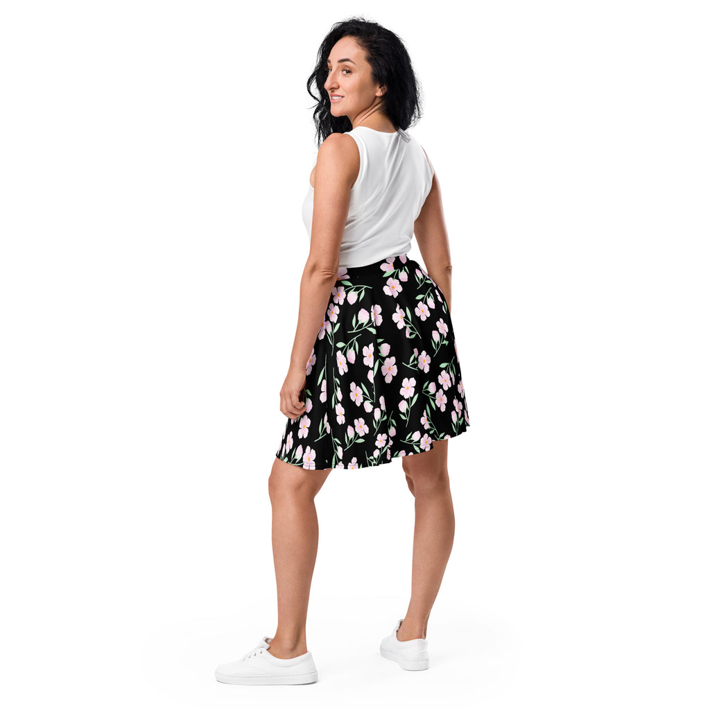 Women’s black floral skater skirt with pink flowers green stems flared silhouette flowy high waisted upf 50 recycled fabric